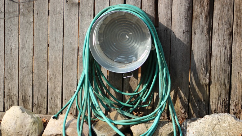 Metal bucket hose storage