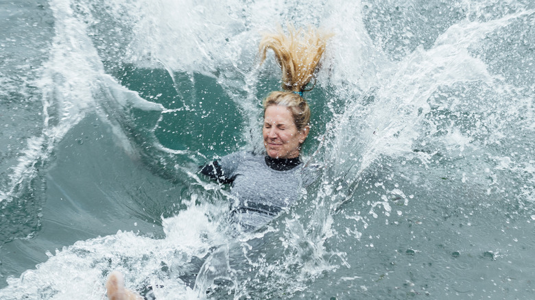 Woman falling into water with clothes on