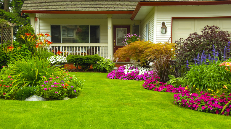 Home with flower beds in yard used as edging