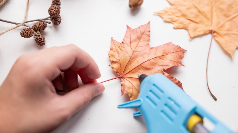 Applying hot glue to leaves