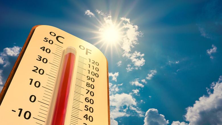 Thermometer with high temperature reading under sunny sky