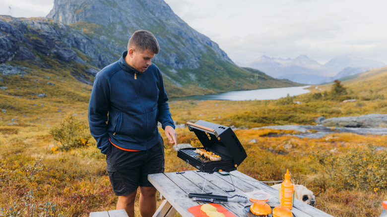 Man grilling at camp