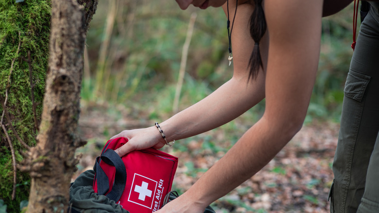 Hiker packing a first aid kit 