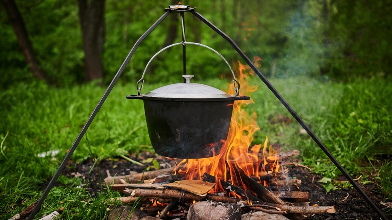 Cast iron Dutch oven over a fire 