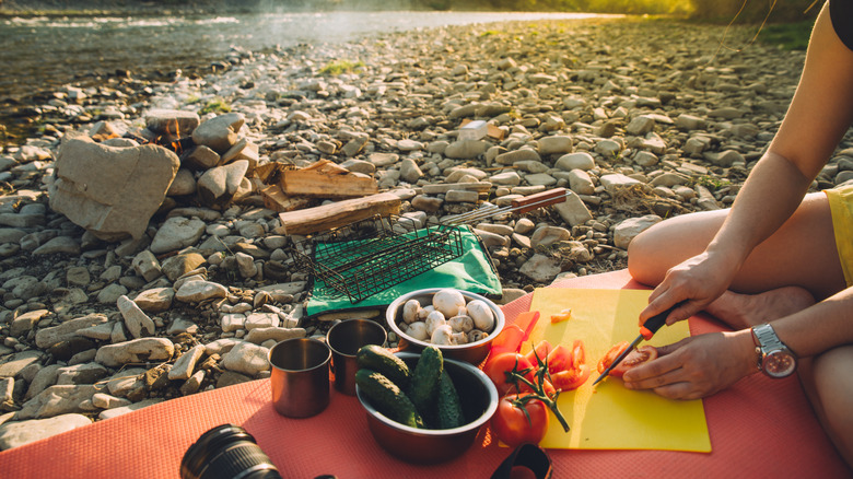 Woman preparing fresh food at campsite