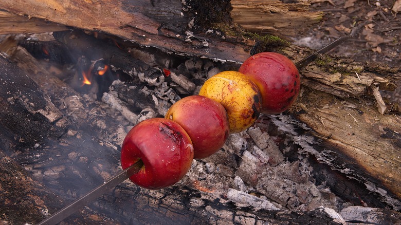 Apples roasting over fire