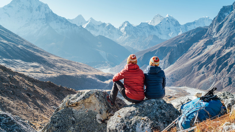 Couple seated and looking at view near Everest base camp