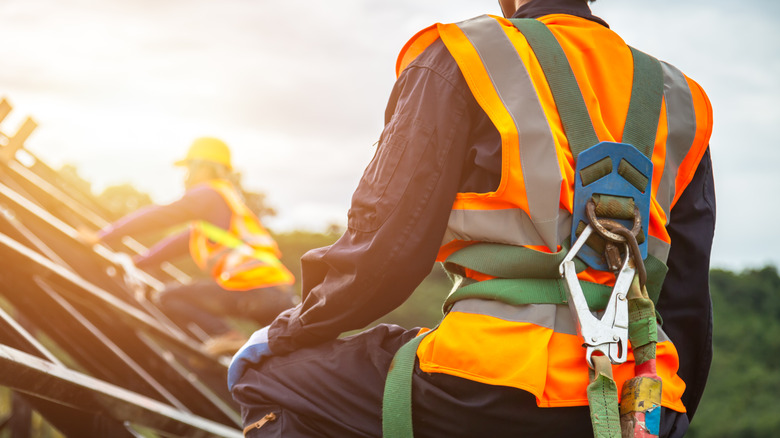 Construction workers wearing safety harnesses