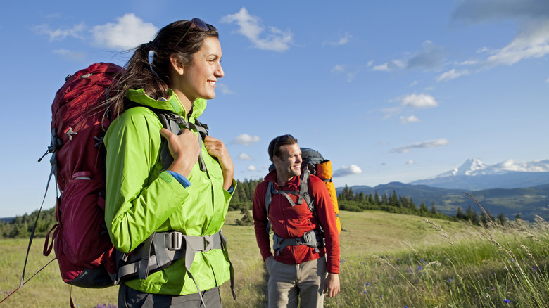 Male and female hiker wearing backpacks