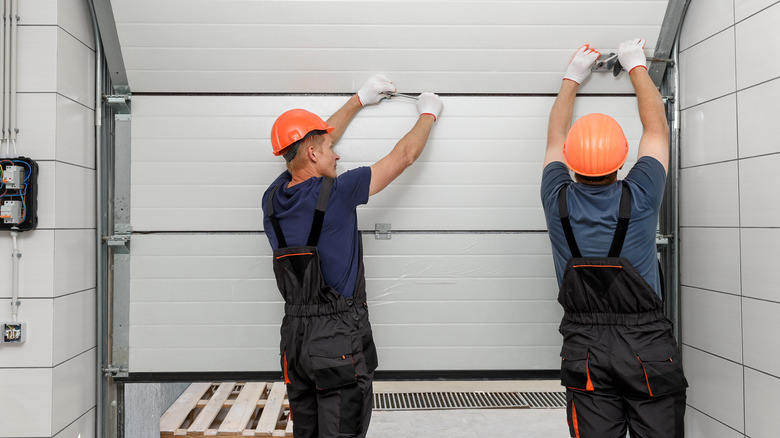 Workers replacing a garage door 