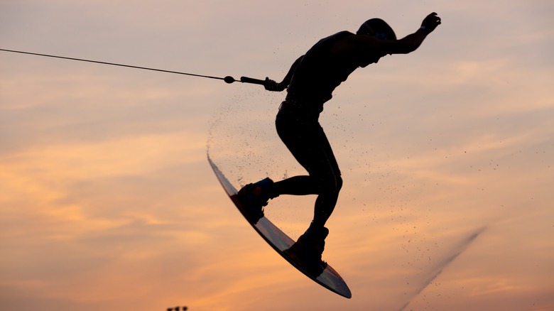 Shot of man wakeboarding with sky in background