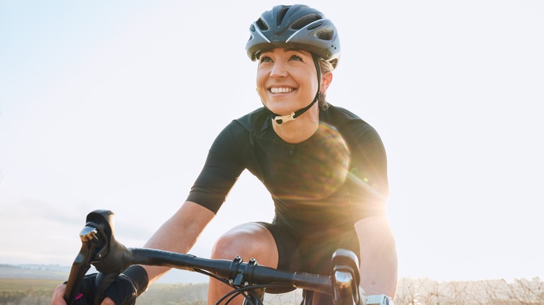 Smiling woman cycling 