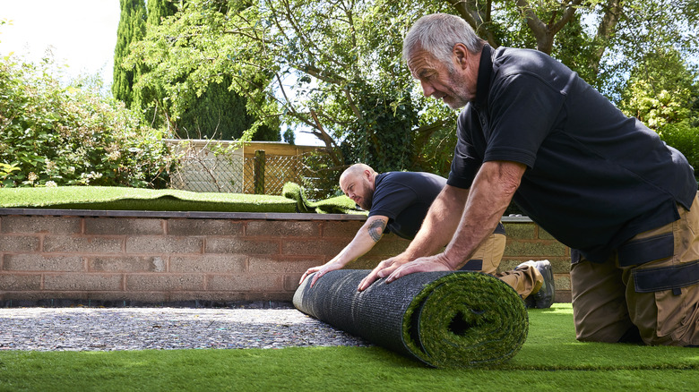 workers installing artificial grass