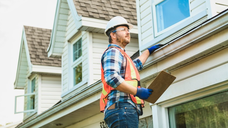 Contractor examining house