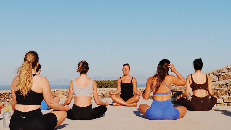 Group of woman doing yoga outdoors 