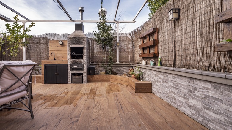 Wooden patio with outdoor kitchen and sofas