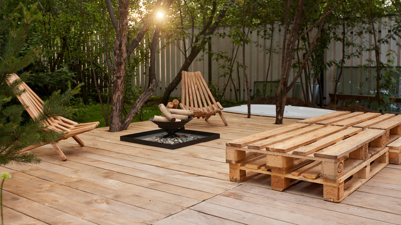 Wooden patio with wooden chairs and firewood