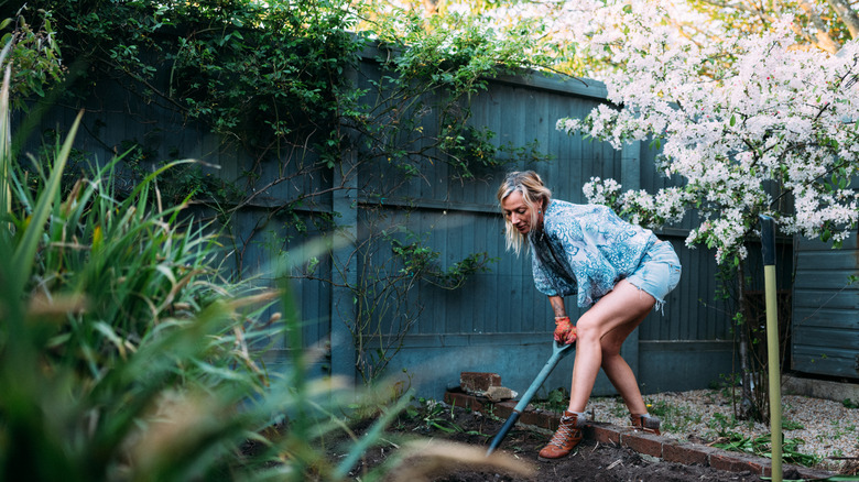 Woman working soil in her garden