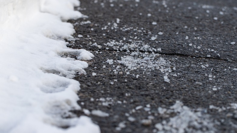 Road salt on pavement near snow