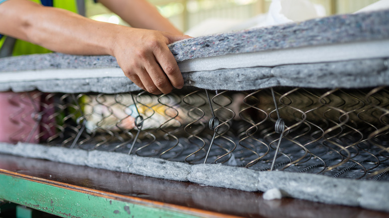 A mattress being cut open to get to the springs inside