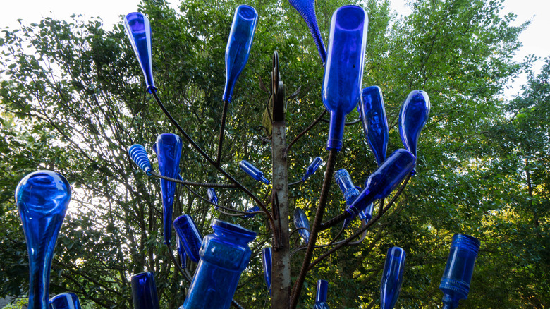 Homemade bottle tree in garden