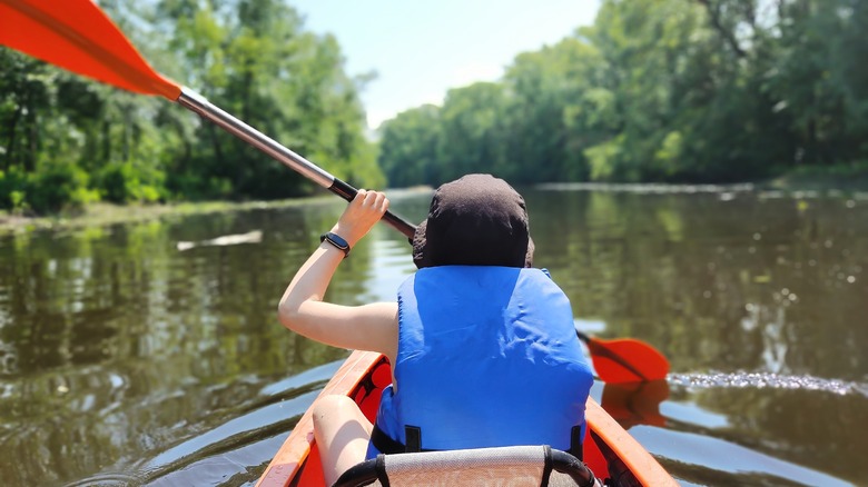 kid kayaking with life jacket