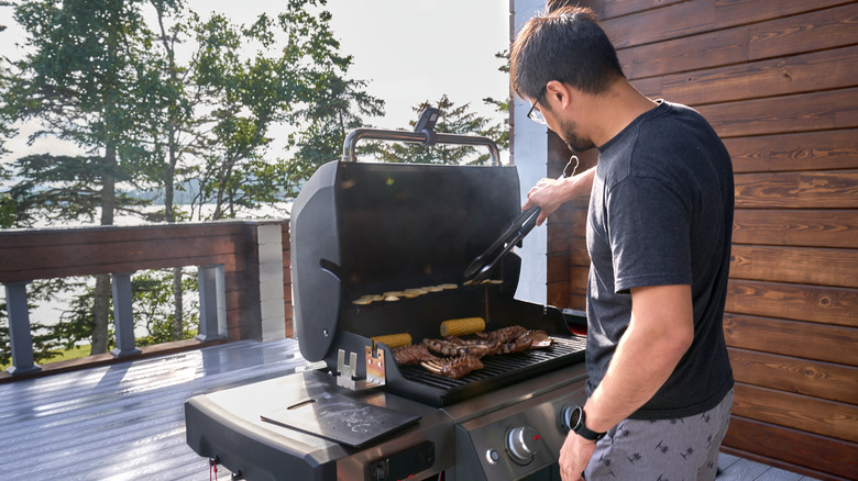 Man grilling on the back deck