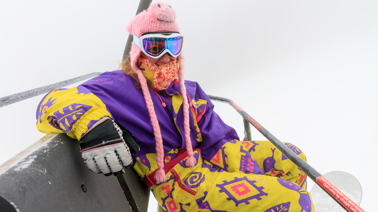 Snow skier in ski suit, smiling