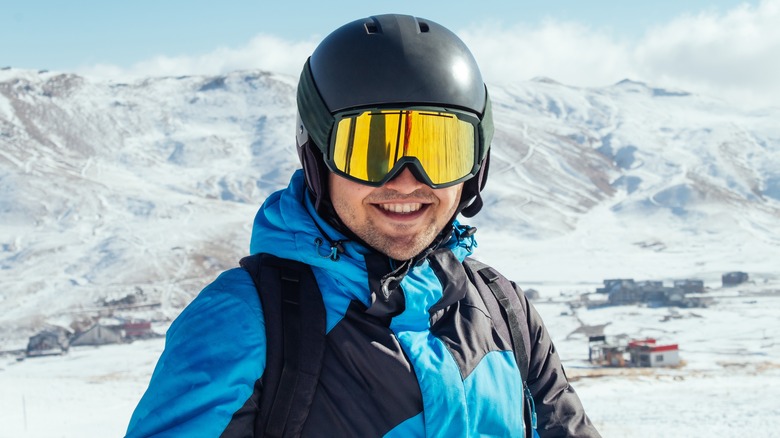 Skier with helmet, smiling