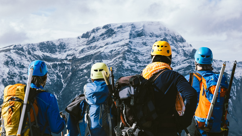 Hikers staring at mountain with gear