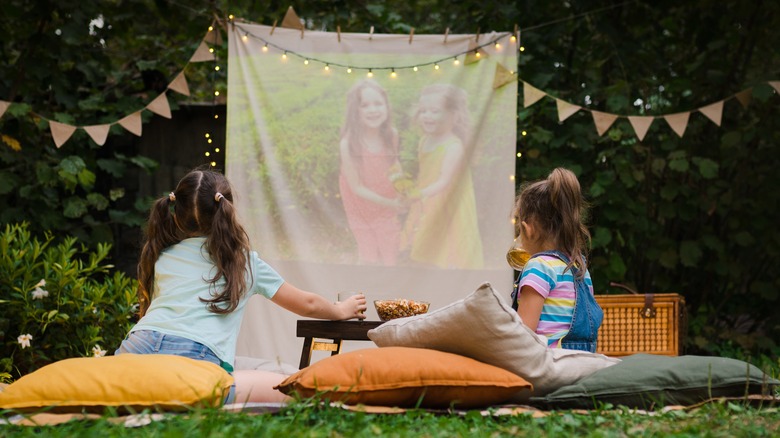 Kids watching movies outside