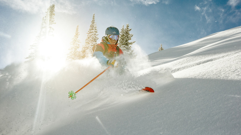 A person skiing down a slope in snow