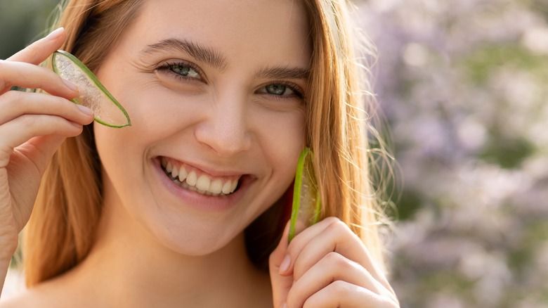 Girl with aloe slices outside