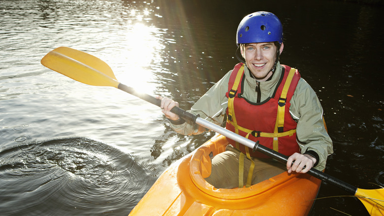 Smiling kayaker with his hands in power position