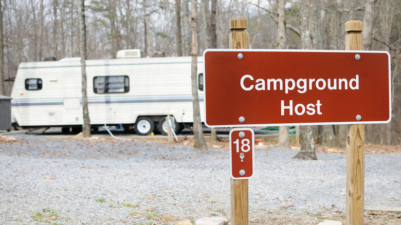 Campground host it with trailer in the background 