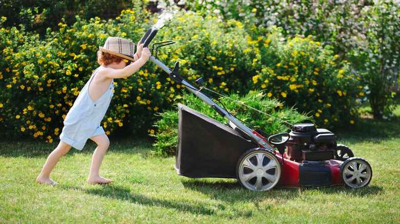 Child pushing lawnmower