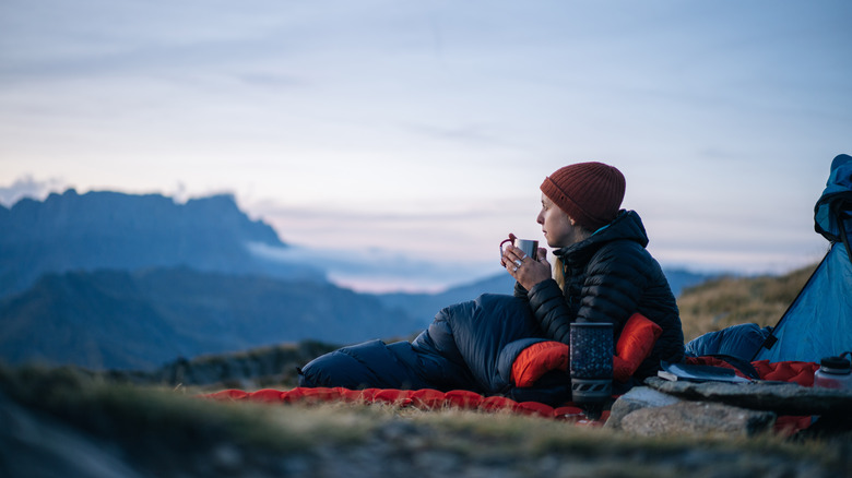 Camper drinking hot beverage