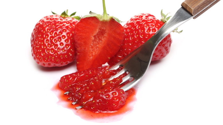 Fork smushing strawberry