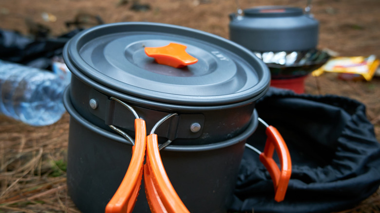 Cookware stacked up at campsite