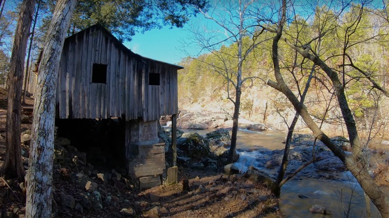 View of cabin near a creek on the Ozark Trail in fall