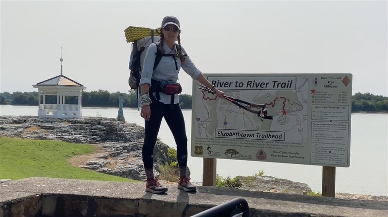 Hiker standing near sign of River to River Trail in Illinois