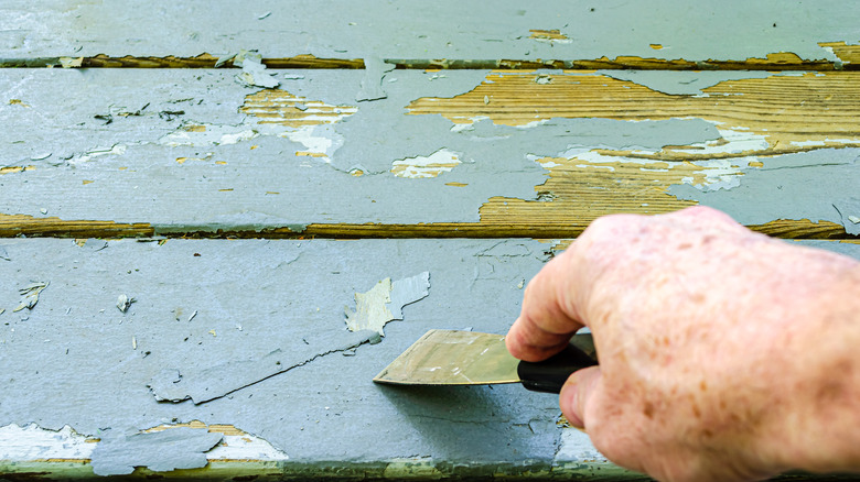 scraping paint on wood porch