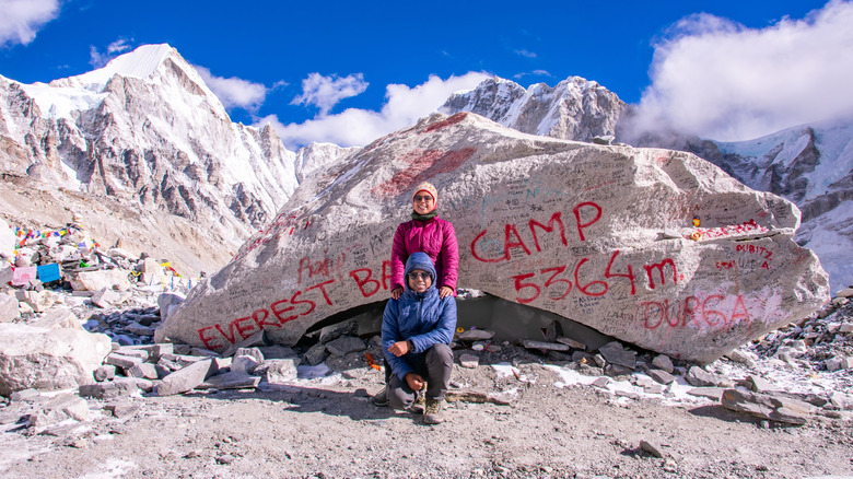 Two mountaineers at Everest Base Camp, smiling