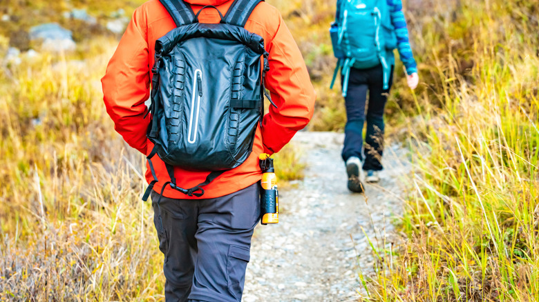 Hiker walking with bear spray attached to hip