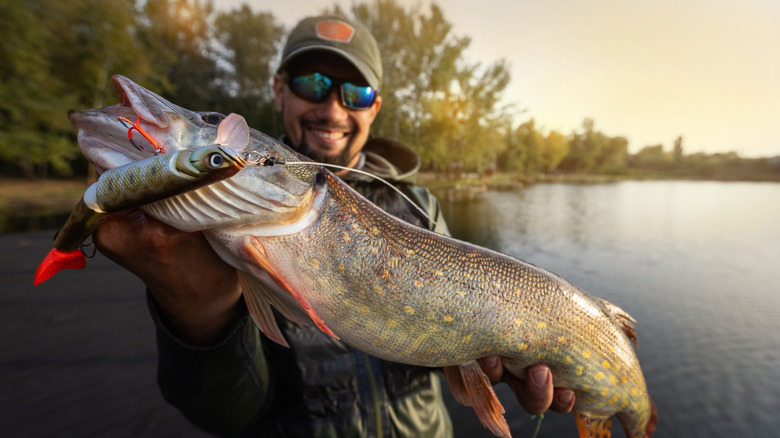 Fisherman smiling with pike