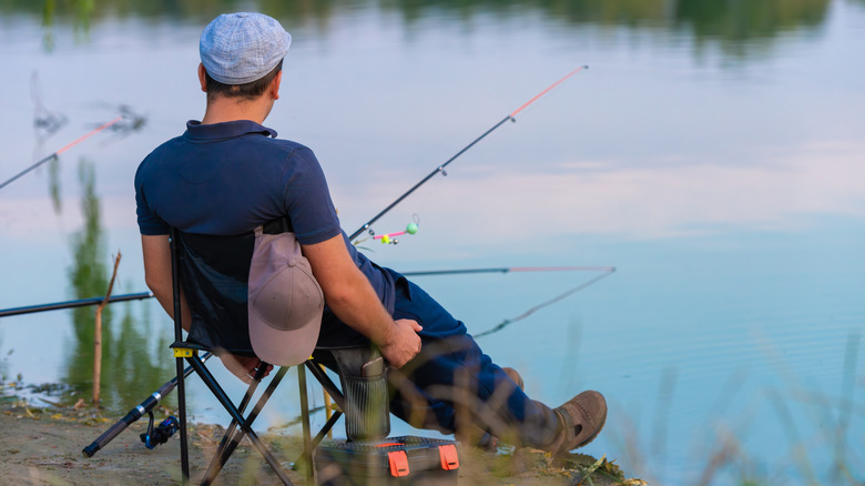 Fisherman sitting on bank casually