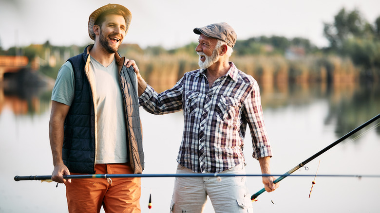 Two fishermen talking and laughing