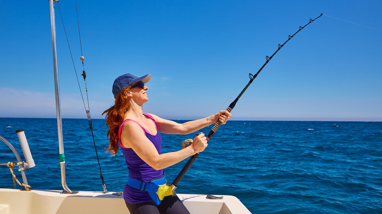 Female angler fishing off of boat