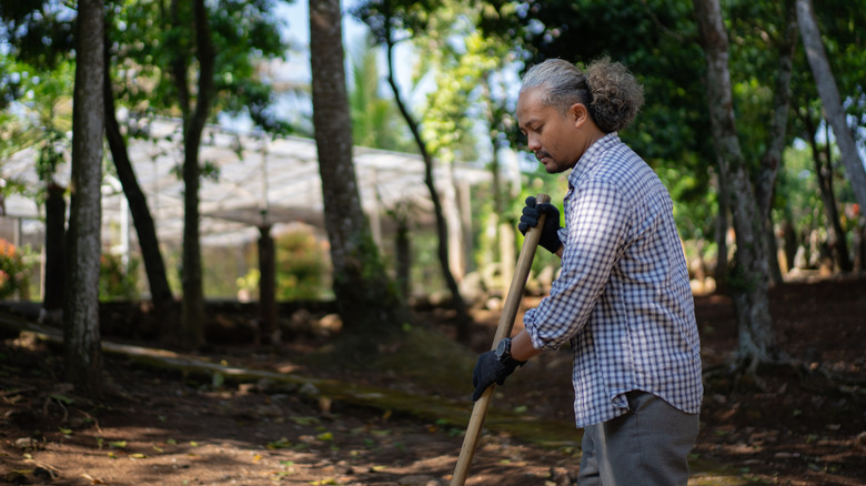 Man using broom on ground