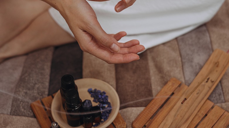 Hands applying essential oil